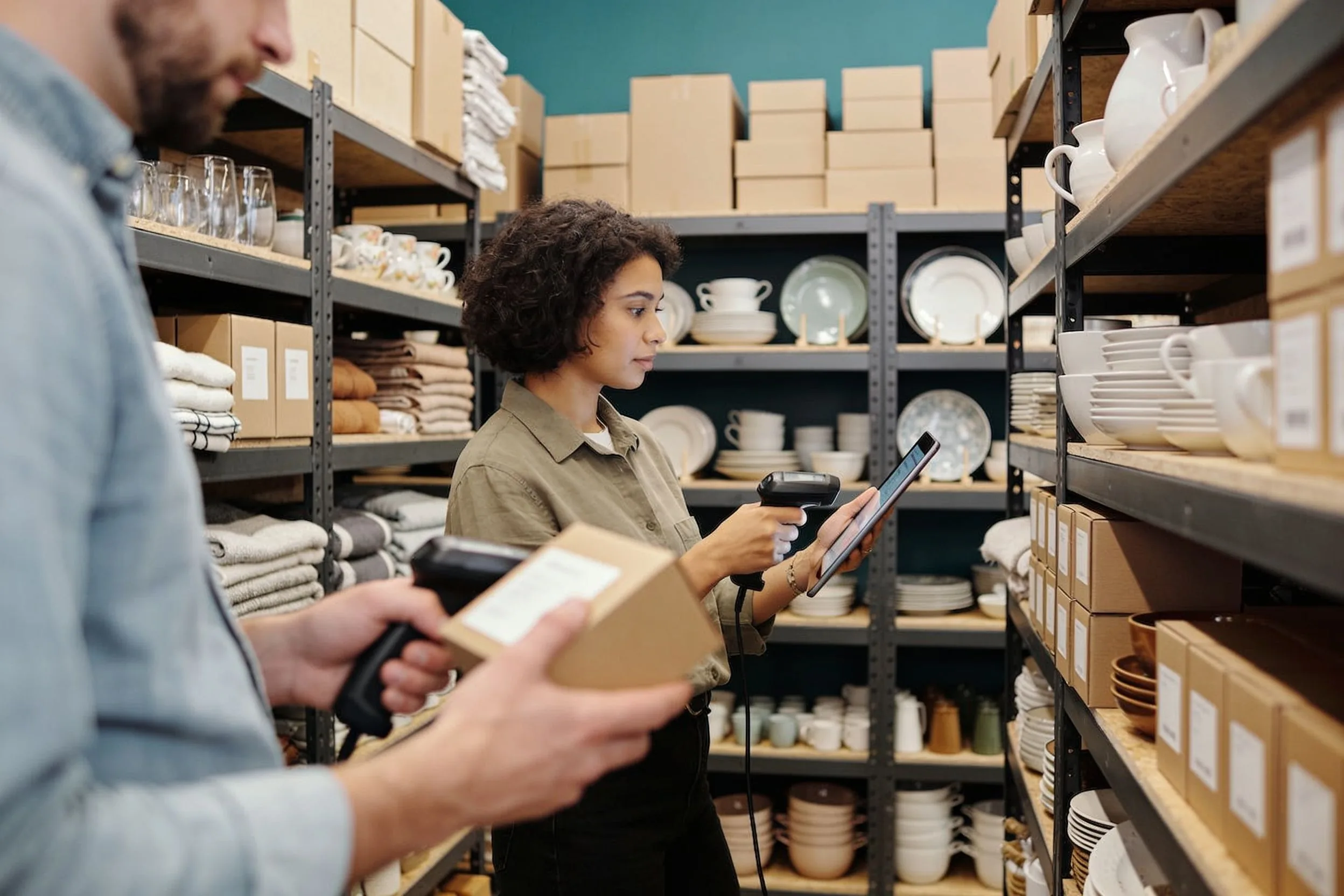 Retail team checking home-goods stock in a boutique storage room